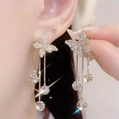 Shiny butterfly rhinestone earrings with pearl tassel, elegant, long dangle.