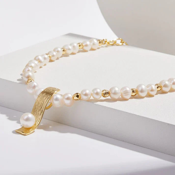 Pearl necklace with minority-inspired fashion pendant, elegant for women.
